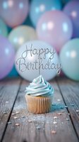 Cupcake with blue frosting and Happy Birthday topper on wooden surface, pastel balloons in background, sprinkles scattered around for celebration.