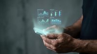 Business professional analyzing holographic data visualization charts and graphs floating above hands for financial technology presentation.