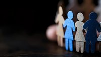 Paper cutout figures representing diversity and inclusion in workplace teamwork and human resources management concepts.