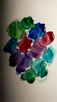 Abstract watercolor paint blobs in vibrant colors on textured paper. Artistic fluid brushstrokes create organic shapes for creative projects and designs.