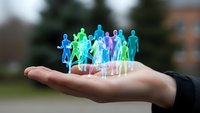 Hand holding holographic diverse group of people figures representing teamwork, community connection and human resources management concepts.