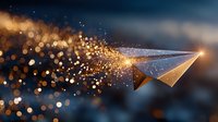 Golden paper airplane dissolving into sparkling particles against starry night sky background with magical bokeh light effects and glowing trail.