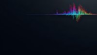 Colorful audio waveform visualization with rainbow spectrum frequencies on dark background for music production and sound engineering applications.
