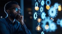 Young African American businessman in glasses contemplating innovative solutions with glowing light bulbs and digital gears interface, night office setting.
