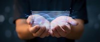 Hands holding glowing digital brain hologram with neural network connections, representing artificial intelligence, technology innovation, and futuristic computing solutions.