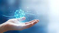 Human hand holding glowing geometric network sphere with digital connections and light effects on blue gradient background for technology concepts.