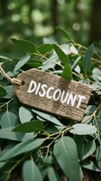 Rustic wooden tag with discount text resting on green leaves, evoking natural eco-friendly sale concept for retail and marketing.