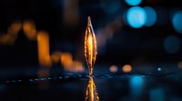Glowing golden crystal ornament reflecting on glossy surface against blurred blue bokeh lights creating magical atmospheric composition.