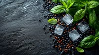 Fresh green basil leaves with scattered black peppercorns and melting ice cubes on dark slate stone background, culinary composition for food photography.