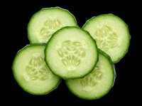 Fresh cucumber slices isolated on transparent background, ready for culinary designs, recipe graphics, food packaging, t-shirt prints, stickers, and print-on-demand products.