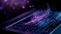 Glowing purple and blue digital wave flows over laptop keyboard with sparkles and light effects against dark background, modern technology concept.
