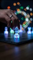 Businessman hand reaching for glowing digital chess pawn piece on tablet screen with colorful bokeh lights background representing strategic planning and leadership.