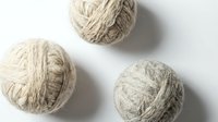 Three balls of natural jute twine arranged on white background, suitable for craft projects, packaging, gardening, and decorative applications.