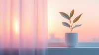 Small potted plant on windowsill against blurred pink and orange sunset sky background creates peaceful minimalist home atmosphere with soft dreamy lighting.