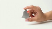 Hand holding small paper house model on white background for real estate investment mortgage property concept.