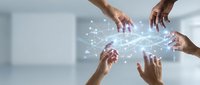 Business team hands connecting digital network with glowing data streams and light effects in modern office environment for teamwork collaboration.