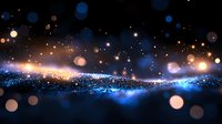 Magical glowing wave of blue and gold particles with bokeh effect against dark background creates ethereal atmosphere for festive designs and celebrations.