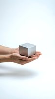 Male hands holding metallic silver cube on white background isolated for business concept presentations and design projects.
