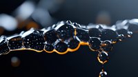 Glowing orange light illuminates dark water drops in macro photography, creating dramatic contrast and abstract shapes against black background. Artistic liquid photography.
