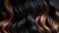 Luxurious dark brown and caramel balayage wavy hair texture closeup. Shiny healthy hair with smooth waves showing professional coloring technique.