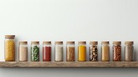 Glass jars filled with colorful grains, legumes, spices and cooking ingredients arranged in row on wooden shelf against neutral wall, pantry organization.