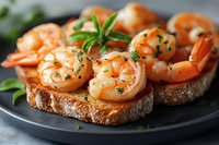 Grilled shrimp bruschetta with fresh herbs and garlic on toasted bread slices served on dark plate, close up view with selective focus. Appetizing seafood starter.