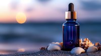 Cobalt blue glass dropper bottle with seashells on sandy beach at sunset, ocean horizon and golden sun in blurred background. Aromatherapy and wellness concept.