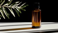 Amber glass essential oil bottle with dropper cap on white surface with olive branch shadow, natural skincare and aromatherapy product mockup.