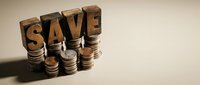 Wooden letter blocks spelling SAVE stacked on coin piles representing financial savings, budgeting and money management concepts for business planning.