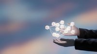 Hands holding glowing network nodes against sunset sky, representing digital connection, technology innovation, and business communication for web design and corporate projects.
