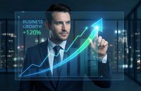 Professional businessman touching holographic growth chart showing 120% business increase with upward arrow in modern office environment at night.