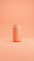 Coral pink aluminum beverage can on matching background for product mockup and branding design projects.