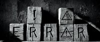 Wooden blocks spelling error with warning triangle symbol and hammer on dark textured surface for risk management and mistake concept designs.