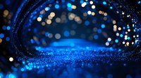 Magical blue glitter background with bokeh lights and sparkles creating dreamy atmosphere for festive designs and holiday celebrations.