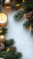 Festive winter border with glowing candle, pine branches, golden ornaments, pinecones and warm fairy lights on white background. Perfect for seasonal designs.