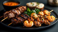 Grilled beef and shrimp skewers served on black plate with dipping sauce, garnished with fresh herbs. Surf and turf kebabs showing grill marks and caramelization.