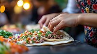 Young woman serving fresh tacos with colorful toppings at outdoor gathering, perfect for food, culinary, and entertaining content.