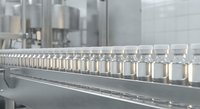 Industrial production line with glass jars moving on conveyor belt in modern manufacturing facility for food processing and packaging operations.