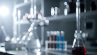 Blurred laboratory equipment with glassware and test tubes creating bokeh effect for scientific research and chemistry backgrounds.