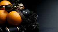 Fresh oranges decorated with black silk ribbon and pine branches on dark background, elegant holiday food styling for seasonal greeting cards and winter designs.