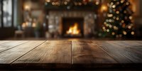 Rustic wooden table with cozy Christmas living room background featuring fireplace and decorated tree for holiday product display.