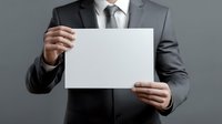 Businessman in grey suit holding blank white paper mockup against grey background. Professional corporate presentation template for advertising and design.