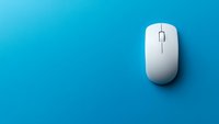White wireless computer mouse isolated on blue gradient background, casting subtle shadow for modern minimalist tech workspace setup.