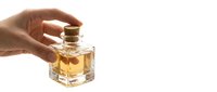 Hand holding square glass bottle with golden amber liquid and cork stopper, isolated on white background for fragrance, perfume, or luxury product packaging design.