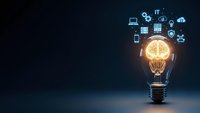 Glowing light bulb with digital technology icons floating above representing innovation, creativity and smart solutions for business development.