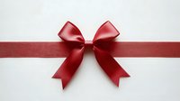 Red satin ribbon bow on white background for gift wrapping, holiday decorations, and festive design projects.