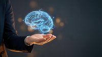 Businessman holding glowing digital brain hologram in cupped hands representing artificial intelligence, innovation and futuristic technology concepts.