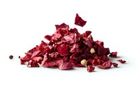 Dried red rose petals and buds scattered in pile on white background, aromatic natural organic ingredients for tea, potpourri and spa treatments.