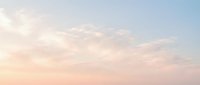 Soft pastel sky with fluffy white clouds at sunset or sunrise creating dreamy atmosphere for backgrounds, meditation apps, wellness content, and peaceful designs.