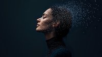 Young African American woman in profile with closed eyes and curly hair against dark background, water drops or glitter creating magical sparkle effect around face.